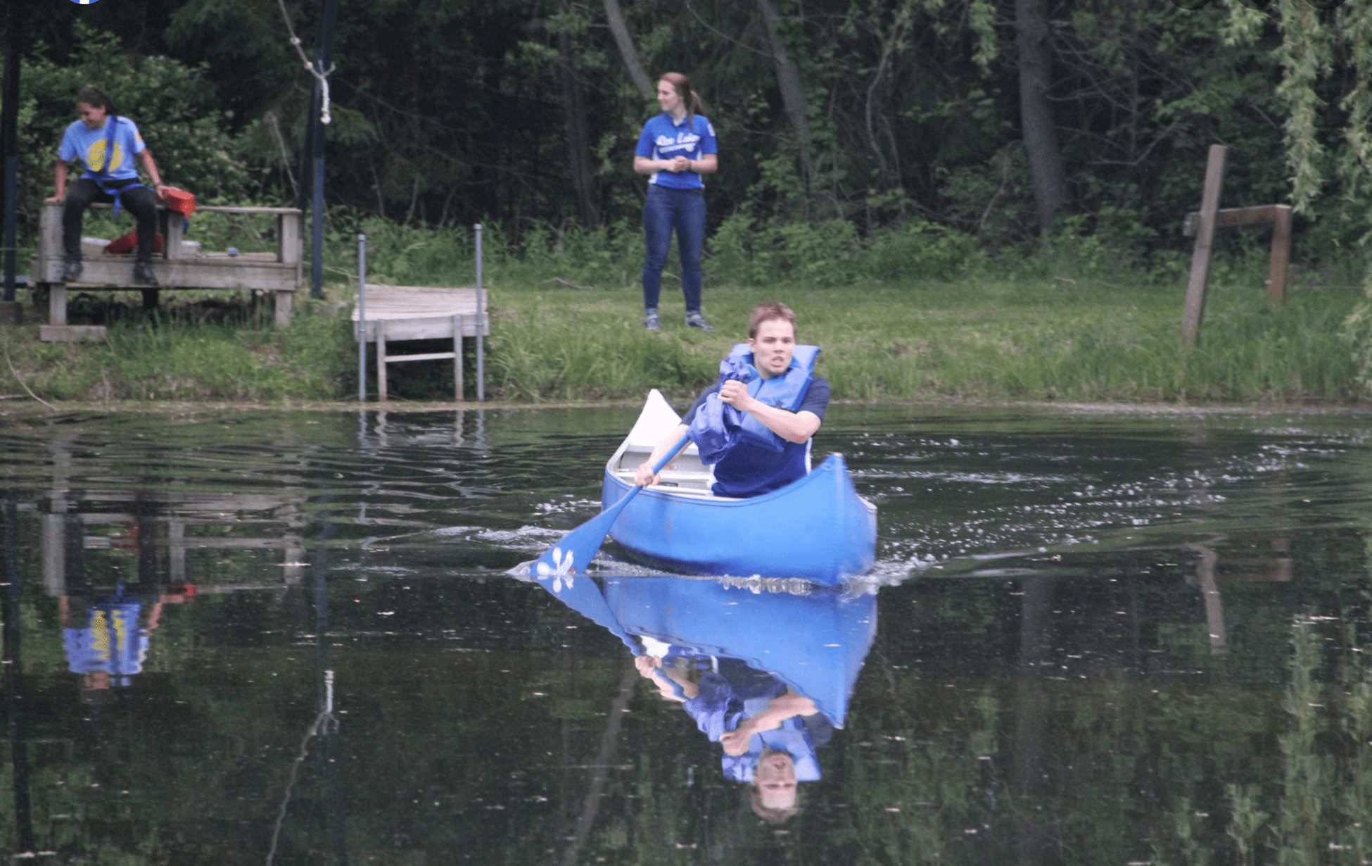 Camper in blue canoe on Lake Jake