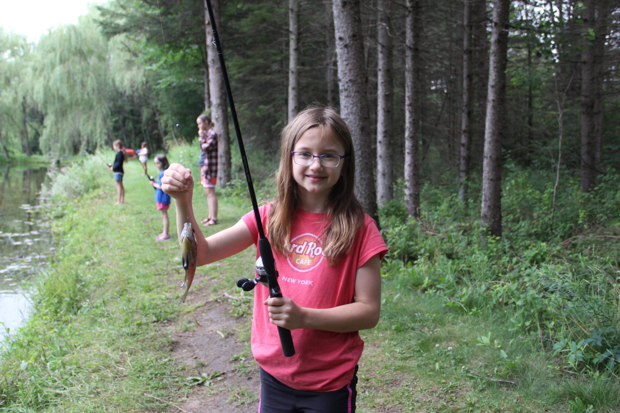 Girl Camper holding up fish